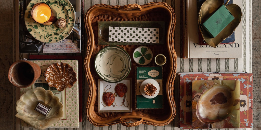 Hadley Tray In Natural rattan on a coffee table with a selection of product