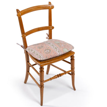 Photo of Sharland-England's Victorian blonde beech wood hall chair featuring curved backs set with ivorine roundels, caned seating and a handmade tie-back seat cushion, in Pierre Frey’s Kalamkar in Pétale by Braquenié fabric.